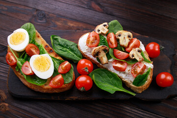 Bruschettas with eggs, vegetables and mushrooms. Homemade italian appetizer, healthy snack, traditional antipasto