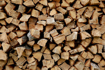
Background of brown firewood stacked on top of each other