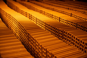 several rows of bricks stacked to dry in a pottery