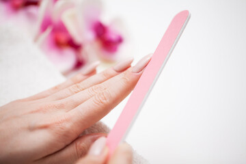 Woman demonstrates a fresh manicure made by a beauty studio