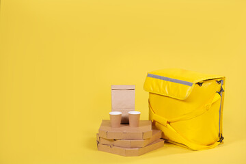 Yellow refrigerator bag for food delivery or for trip to nature and tourism on yellow background...