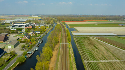 Aerial view of dutch village, canals, railway road and tulip bulb fields