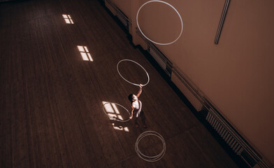 gymnast woman dancing with hula hoops