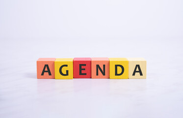 word agenda on colorful wooden cubes on white