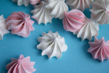 Sweet delicate meringues on a blue background
