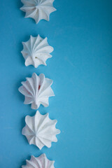 Sweet delicate meringues on a blue background
