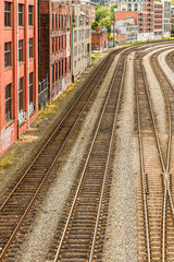 Fototapeta premium Train tracks leading into the urban core