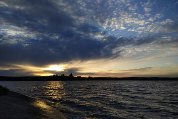 Beautiful sunset sky, reflection of evening sun in a lake