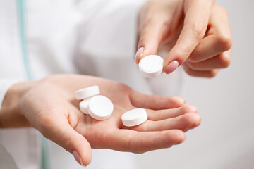 Female doctor holding pills in her hands