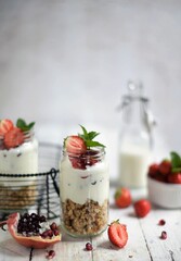 Fresh strawberries , yogurt and homemade granola for healthy breakfast on white background, selective focus.
