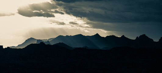 Storm clouds dropping rain over mountains in the Arizona desert