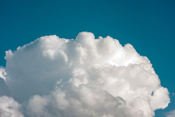 Naklejka na ściany i meble large textured cloud against the blue sky