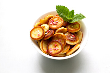 Lovely breakfast with mini pancakes, little hearts and mint. Trendy food concept