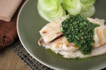 Fish fillet with pesto sauce and lettuce salad