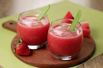 Refreshing strawberry watermelon juice served with ice and celery