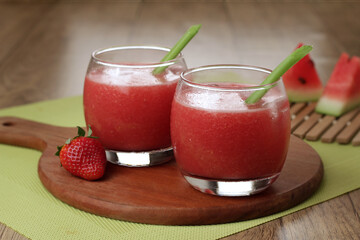 Refreshing strawberry watermelon juice served with ice and celery