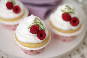 Lemon and vanilla cupcake with whipped cream and raspberry