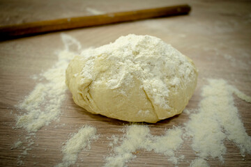 Preparation for pizza dough on wood table with flour
