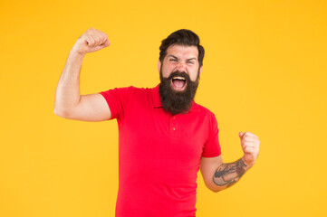 I made it. Happy hipster yellow background. Successful hipster show winning gesture. Victory. Bearded man wear hipster beard. Casual hipster style. Barbershop. Fashion and style. Menswear store