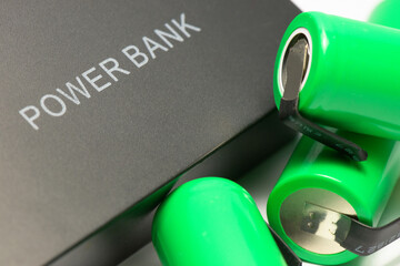 External power bank and new green rechargeable lithium ion battery type 18650. Inscription ‘POWER...