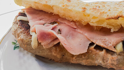 Sandwich with burger and ham in a bun