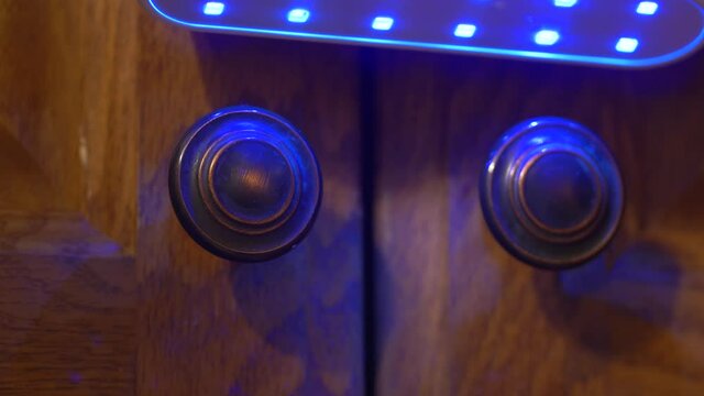Sterilizing cabinet knobs with UV C light during the coronavirus pandemic, Close up shot