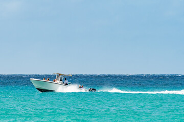 Philipsburg, Sint Maarten. Group of people have fun day sailing the ocean in motor sailboat. Tourists on vacation on tropical Caribbean island coast near Maho Bay Beach.