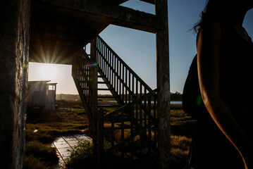 Woman exploring abandoned house.