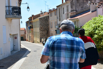 Fototapeta premium Elderly couple in the city of Cannes in France enjoying the view of the old town. Lifestyle and back to travel concept. Back to normal life after pandemic. Quarantine is over.
