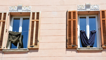 Hanging clothes and windows with shutters, Provence, France. Real life concept.