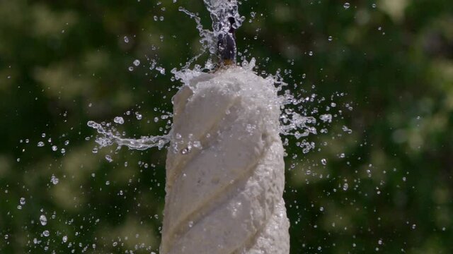 Water fountain in Munich, extreme slow motion 200fps shot on RED Helium 8K with 70-200, camera panning downwards as water splashes