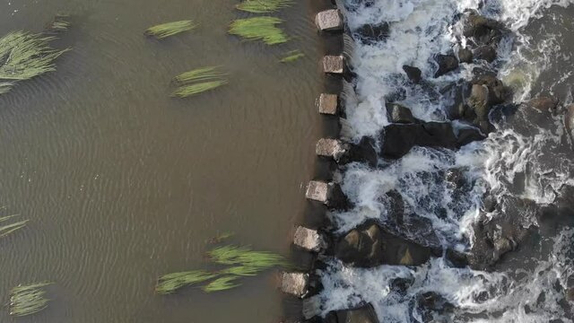 AERIAL DIRECTLY ABOVE Small Stone River Weir With Flowing Water