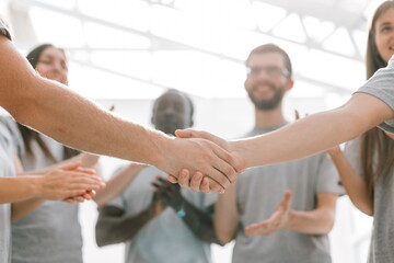 close up. handshake of two students on the background of the st