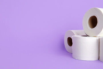 Rolls of toilet paper on color background