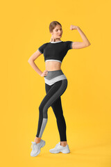 Fototapeta na wymiar Sporty young woman on color background