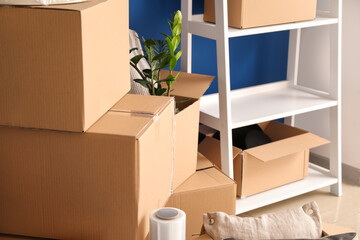 Cardboard boxes with belongings in new flat on moving day