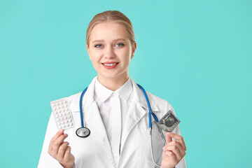 Female gynecologist with different contraceptives on color background