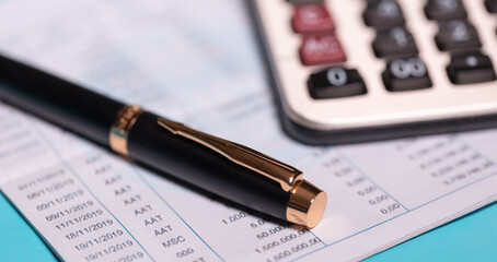 calculator and stationery items on the table for financial activity