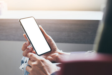 cell phone mockup image blank white screen.woman hand holding texting using mobile on desk at coffee shop.background empty space for advertise.work people contact marketing business,technology