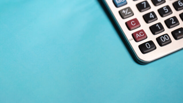 calculator and stationery items on the table for financial activity