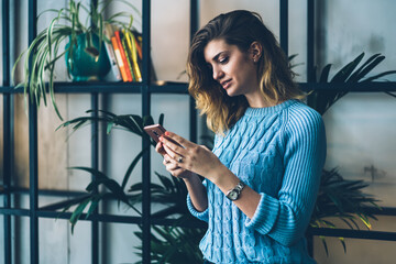 Female student spending time at campus talking via mobile phone with 4g internet