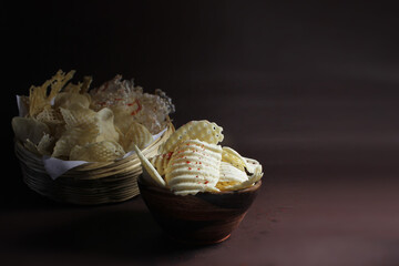 Homemade sundried potato chips and sago wafers.Deepfried and served in wooden bowl.