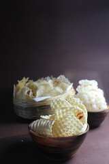 Homemade sundried potato chips and sago wafers.Deepfried and served in wooden bowl.