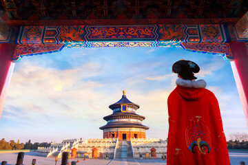 A Chinese woman in a Traditional Winter Dress at Tian Tan - The Temple of Heaven (the Imperial Vault of Heaven - a translation from the name plates) in Beijing, China - obrazy, fototapety, plakaty