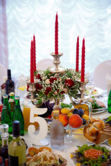 Decor of a wedding party. Wedding table decoration in a restaurant. Glasses, drinks, food. Festive decoration of the interior.