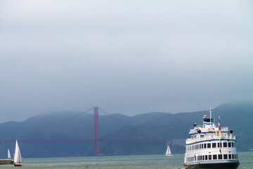 Sailboats and Tour Boat in San Francisco Bay With  The Golden Gate Bridge and The Marin Headlands in The Distance, San Francisco, California, USA