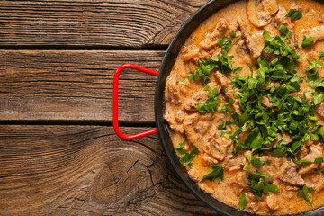 Tasty beef stroganoff on table