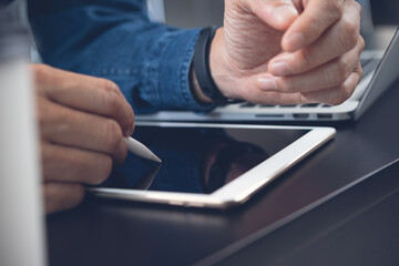 Business man graphic designer using stylus pen working on digital tablet computer