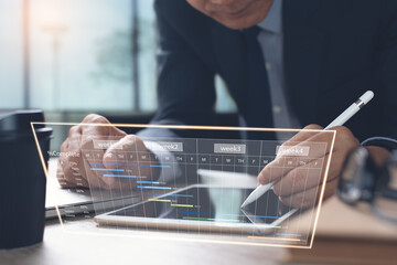 Project manager working on gantt chart on virtual screen in office