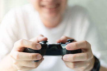 Young man hands holding joystick.Play the video game concept.